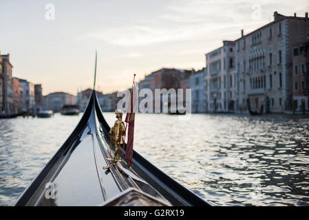 Una chiusura della figura in miniatura nella parte anteriore della gondola con il paesaggio della città dietro, Venezia, Italia. Foto Stock