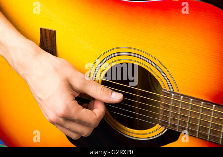 Stretta di mano suonare la chitarra acustica Foto Stock