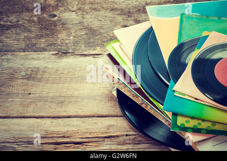 Il vecchio record di vinile su sfondo di legno. Retrò tonica. Foto Stock