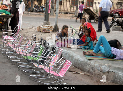 Una povera famiglia nomade vive sul sentiero e guadagnare il sostentamento mediante la vendita di sedie per bambini, a Burns Road a Karachi il Venerdì, Giugno 03, 2016. Venerdì il Ministro delle finanze Ishaq Dar presentato proposte di bilancio per l'esercizio finanziario 2016-17 prima dell'Assemblea nazionale che non mostra alcun rilievo per il medio e inferiore di persone di classe. Foto Stock