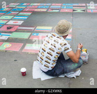 Marciapiede artista in Trafalgar Square, London, Regno Unito - colorata gesso disegni di bandiere nazionali Foto Stock