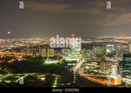 Vista dal Donauturm alla luna piena sorgere , il Vecchio Danubio, Danubio città , Centro internazionale di Vienna ( VIC , UNO City ), Aust Foto Stock