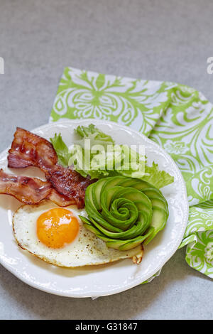 Uova fritte, pancetta e avocado è salito per la prima colazione Foto Stock