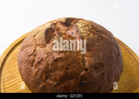 Pane scuro con le briciole sul pannello di legno Foto Stock