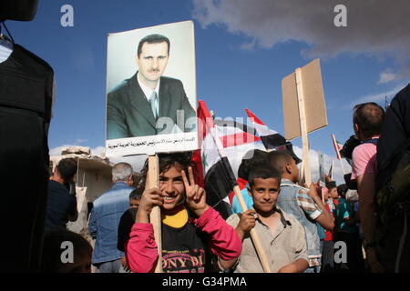 Bambini siriano tenere un ritratto del Presidente siriano Bashar al-Assad in Kokab, Siria, 04 maggio 2016. Ufficiali russi hanno presumibilmente ha contribuito a negoziare un cessate il fuoco tra i sostenitori del regime e gli avversari in città. Foto: FRIEDEMANN KOHLER/dpa Foto Stock