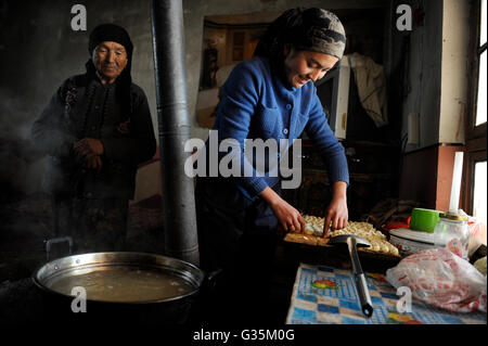 La provincia cinese dello Xinjiang, uighur villaggi intorno a città Kashgar dove uyghur persone vivono , donne di preparare il cibo in cucina, fresche Samsa agnello farcito torta a base di carne Foto Stock