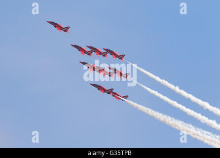La RAF frecce rosse aerobatic team volare in formazione contro un cielo blu, Duxford Airshow, UK; il concetto di leadership Foto Stock