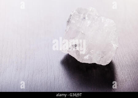 Immagine ravvicinata di un frammento di roccia minerale cristallo su una superficie scura Foto Stock