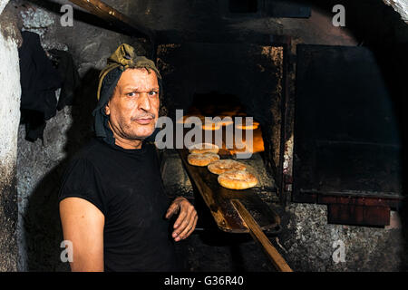 Fez, in Marocco - 11 Aprile 2016: Ritratto di un fornaio in piedi di fronte a un tradizionale forno pane in Fez, in Marocco. Foto Stock