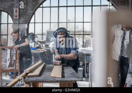 Carpenter la levigatura del legno in antico laboratorio di restauro Foto Stock