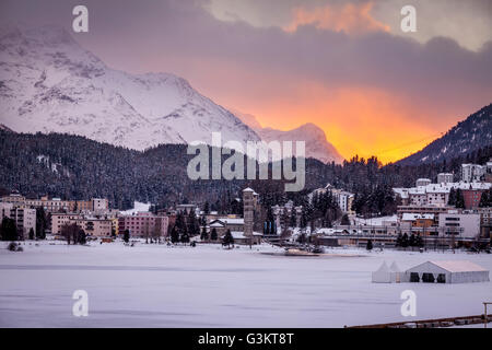 Villaggio sotto la montagna su paesaggi innevati al tramonto, Sankt Moritz, Svizzera Foto Stock