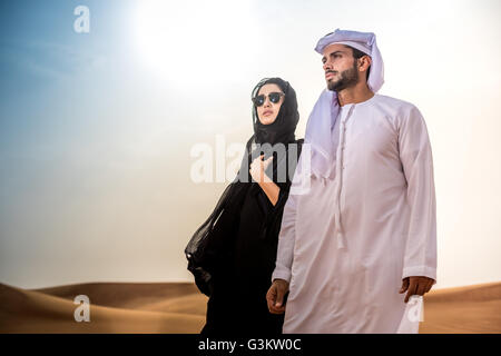 Giovane indossando il tradizionale medio orientale vestiti nel deserto, Dubai, Emirati Arabi Uniti Foto Stock