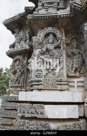 Ornati pannello parete bassorilievi raffiguranti Krishna ballare sulla testa di serpant Kalia. Tempio Kedareshwara, Karnataka, India Foto Stock