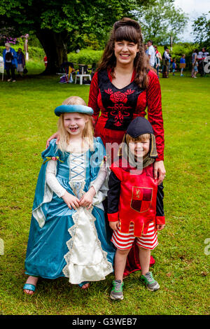 Una donna locale e i bambini vestiti in costume medievale presso la Fiera medievale di Abinger, Surrey, Regno Unito Foto Stock