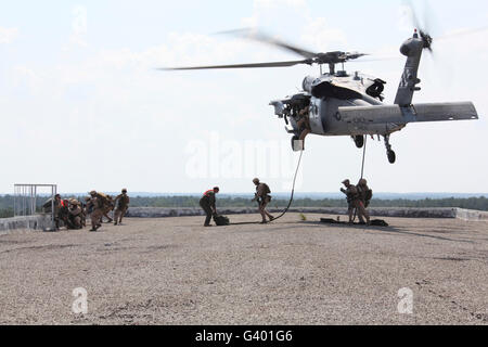 Marines fast-corda sul loro obiettivo da un bilico MH-60S Seahawk. Foto Stock