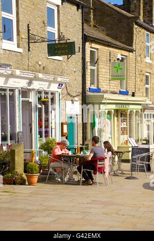 Le persone al di fuori seduta Cafe. Cafe1618,16 Market Place, Middleton in Teesdale, County Durham, England, Regno Unito, Europa. Foto Stock