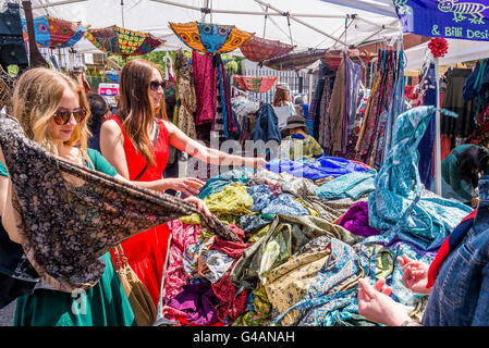 Le donne perusano i vestiti in bancarella di Street Market, Foto Stock