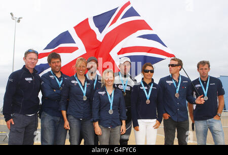 Il manager olimpico della RYA Stephen Park (a sinistra) si unisce ai medalisti durante l'evento di test dei Giochi Olimpici di Londra del 2012 e la Regata Internazionale di Weymouth. Foto Stock