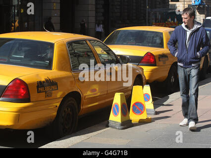 Un uomo passa accanto ai veicoli americani parcheggiati in preparazione delle riprese della Z Guerra Mondiale a George Square, Glasgow. Foto Stock