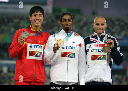 Jason Richardson (al centro) degli Stati Uniti che ha vinto l'oro, Liu Xiang (a sinistra) della Cina che ha vinto l'argento e Andrew Turner della Gran Bretagna che ha vinto la posa del Bronzo sul podio per la cerimonia di medaglia di Hurdles da 110 m degli uomini durante il quarto giorno dei Campionati mondiali di atletica IAAF allo Stadio Daegu a Daegu, Corea del Sud. Foto Stock