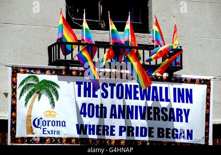 New York City: Arcobaleno di bandiere e di un banner di proclamare il 40 anni di Gay Pride appendere dalla facciata di un celebre Stonewall Inn Foto Stock