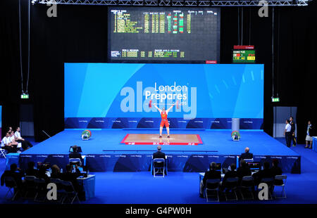 Olympics - Weightlifting - London 2012 Test Event - Day One - Excel Arena. Una visione generale dell'arena come la Cina Yue Kang compete durante il London Olympic Games 2012 Test Event alla Excel Arena di Londra. Foto Stock