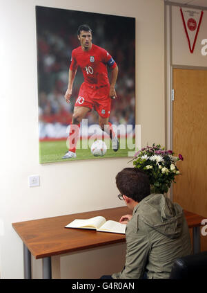 Calcio - Tribute Gary Speed. Un fan firma il libro di ricordi per Gary Speed all'interno della Welsh Football Association ofiices, Cardiff. Foto Stock