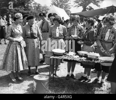 La regina Elisabetta II, patrona della Girl Guides Association, guardando le Guide preparare le verdure, mentre ha girato il campo del mondo di guida a Windsor Great Park, Berkshire. Foto Stock