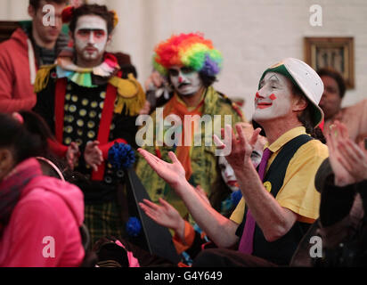 Clown che indossano il costume pieno assistono ad un servizio in memoria del clown celebrato Joseph Grimaldi, alla chiesa della Santissima Trinità a Dalston, Londra orientale. Foto Stock