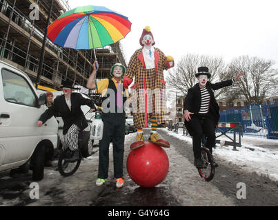 Clown in costume pieno arrivano alla chiesa della Santissima Trinità a Dalston, a est di Londra, per assistere ad un servizio in memoria del celebre clown Joseph Grimaldi. Foto Stock