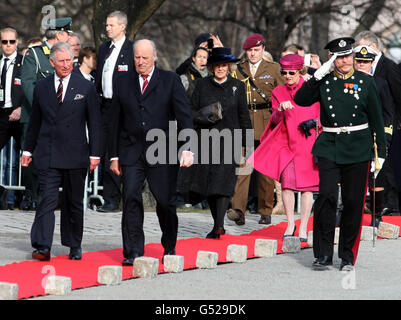 Il Principe di Galles e il Re Harald di Norvegia sono seguiti dalla Duchessa di Cornovaglia e dalla Regina Sonja, durante una cerimonia di posa della corona presso il Monumento Nazionale, la Fortezza di Akershus, in Norvegia durante il tour reale della Scandinavia, come parte delle celebrazioni del Giubileo del Diamante della Regina. Foto Stock