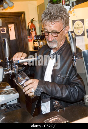 Eddie Jordan versa una pinta di Guinness al Toucan Bar di Soho, Londra, dopo aver appreso che sarà nominato ufficiale dell'Impero britannico (OBE) in riconoscimento per i suoi servizi di beneficenza e corse automobilistiche. Foto Stock