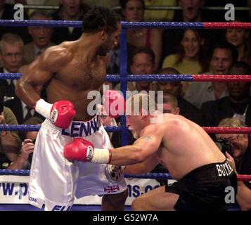 Il Challenger Frans Botha (R) va in pugno dopo aver ricevuto un pugno dal campione dei pesi massimi del mondo Lennox Lewis durante la loro lotta per i pesi massimi WBC e IBF alla London Arena. Lewis batte Botha nel secondo turno. Foto Stock