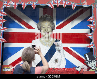 Una vetrina con una foto della Regina interamente composta da Lego presso il negozio di giocattoli Hamleys di Regent Street, Londra, in preparazione al Giubileo dei Diamanti. Foto Stock