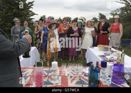 Team building, lavora per un giorno libero dal lavoro. Le signore del Raynes Park Bakery, a sud-ovest di Londra, hanno un giorno di ferie per festeggiare il Giubileo di Diamante della Regina. Bottiglia di champagne aperta. Epsom Downs, Surrey, Inghilterra 2012, 2010s UK HOMER SYKES Foto Stock