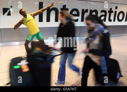 I passeggeri che arrivano al Terminal 5 dell'Aeroporto di Heathrow sono accolti da una statua di cera creata da Madame Tussauds London dello sprinter giamaicano Usain Bolt, che è stato ufficialmente presentato all'aeroporto prima di essere esposto all'attrazione nel centro di Londra lunedì 23 luglio. Foto Stock