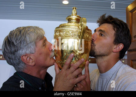 NESSUN USO COMMERCIALE: Goran Ivanisevic (a destra), della Croazia, celebra con il trofeo con suo padre Srdjan Ivanisevic dopo aver battuto il Pat Rafter australiano, durante la finale maschile dei Campionati di tennis al prato 2001 a Wimbledon, a Londra. Foto Stock