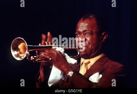 1968: Il musicista jazz e cantante Louis Armstrong in azione sulla sua tromba in un locale notturno britannico. Foto Stock