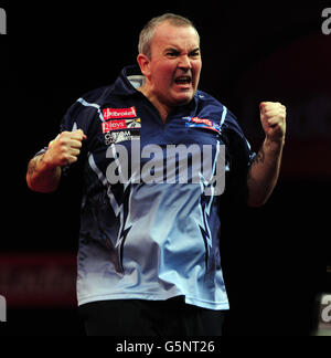 Phil Taylor celebra la sconfitta di Raymond van Barneveld durante il campionato mondiale di freccette Ladbrokes.com ad Alexandra Palace, Londra. Foto Stock