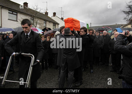 La bara di Dolours Price viene trasportata dalla sua casa di famiglia Slievegallion Drive ad Andersontown West Belfast dai suoi due figli Danny e Oscar davanti e il suo ex attore partner Stephen Rea (dietro a destra) alla chiesa di Sant'Agnese e poi sul cimitero di Milltown per la sepoltura. Foto Stock