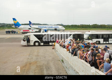 I turisti in coda a salire a bordo del bus per il trasferimento a Thomas Cook aereo aeroporto di Corfù, Grecia, Europa Foto Stock