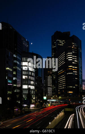 Una trafficata strada di notte a Tokyo. Foto Stock