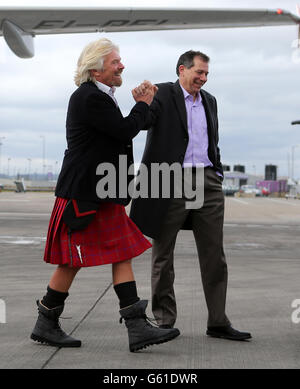 Sir Richard Branson si congratula con il nuovo amministratore delegato di Virgin Atlantic Craig Kreeger (a destra) per il suo arrivo a Edimburgo dopo aver lasciato il volo inaugurale Virgin Atlantic Little Red da Londra Heathrow a Edimburgo. Foto Stock