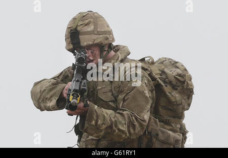 . Un membro di 45 Commando Royal Marines guarda giù le attrazioni della sua arma mentre si prepara prima di Esercitazione Joint Warrior, che coinvolgerà più di 40 navi da guerra, 30 aerei ad ala fissa e 30 elicotteri sulla spiaggia di Barry Buddon in Scozia. Foto Stock