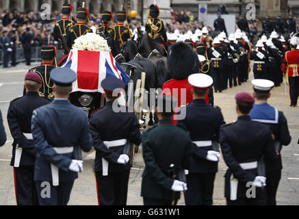 Una bara drappeggiato con bandiera dell'Unione che porta il corpo dell'ex primo ministro Margaret Thatcher viene portata su una carrozza trainata dalla truppa reale del re durante la processione funeraria cerimoniale della baronessa Thatcher, prima dei suoi funerali alla Cattedrale di St Paul, nel centro di Londra. Foto Stock