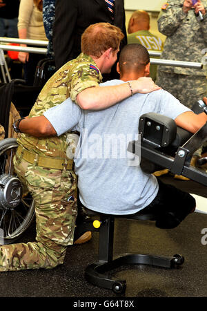 Il principe Harry si pone per una fotografia con un soldato dell'esercito degli Stati Uniti che ha perso entrambe le gambe, durante una visita al Walter Reed National Military Medical Center di Washington, durante il secondo giorno del suo tour di sette giorni negli Stati Uniti. Foto Stock