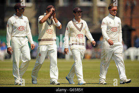 Il capitano del Surrey Vikram Solanki (a sinistra), Zander de Bruyn (2nd a sinistra), Ricky Ponting e Jason Roy lasciano il campo di gioco dopo la sessione mattutina Foto Stock