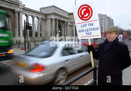 Charles Kingsley Evans nell'area all'angolo di Hyde Park con un cartello contro la tassa di congestione, mentre gli automobilisti sono sulla loro strada per il centro di Londra. * da oggi i conducenti che utilizzano una zona di otto miglia quadrati della capitale tra le 0700 e le 1830 dal lunedì al venerdì devono pagare una tassa di 5. I loro pagamenti sono monitorati rispetto alle immagini digitalizzate registrate da una serie di circa 700 telecamere all'interno e alla periferia della zona. Ci sono sconti per i conducenti che vivono all'interno della zona, e il denaro raccolto dal regime andrà a migliorare i trasporti pubblici. Foto Stock