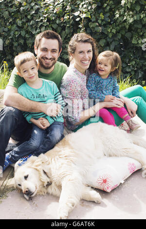 Famiglia con figli piccoli e il cane di famiglia, ritratto Foto Stock