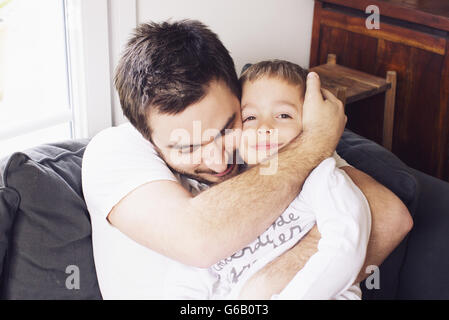 Padre abbracciando bambino, ritratto Foto Stock